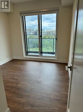 Markham (Unionville) condo for rent - A room with a large window and wooden flooring.