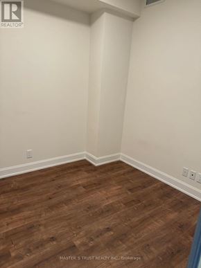 Markham (Unionville) condo for rent - A room with wooden flooring and white walls.