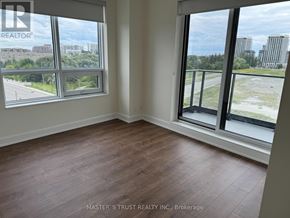Markham (Unionville) condo for rent - A room with a view of the city through large windows.