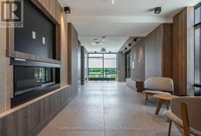 Oakville (Jm Joshua Meadows) condo for rent - A modern living room with a flat screen TV and a view of the outdoors.