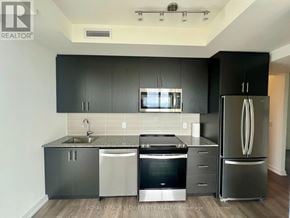 Oakville (Jm Joshua Meadows) condo for rent - A kitchen with black cabinets and stainless steel appliances.