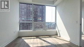 Toronto (North St. James Town) condo for rent - A room with a large window overlooking a cityscape.
