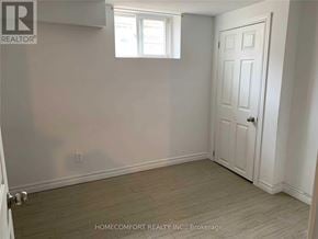 Richmond Hill (Crosby) apartment for rent - A white door is on the right side of a room with a window on the left.