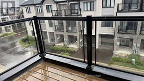 Brantford townhouse for rent - A rainy day in a residential area with apartment buildings.