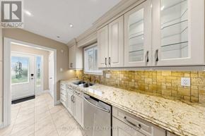Oakville (Wo West) apartment for rent - A kitchen with a granite countertop and white cabinets.