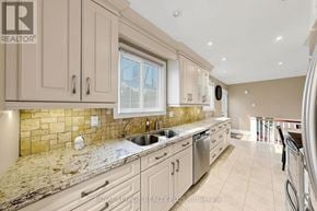 Oakville (Wo West) apartment for rent - A kitchen with beige cabinets and a granite countertop.