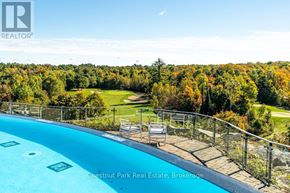 Gravenhurst (Muskoka (S)) condo for rent - A pool surrounded by a metal fence with a view of a golf course.