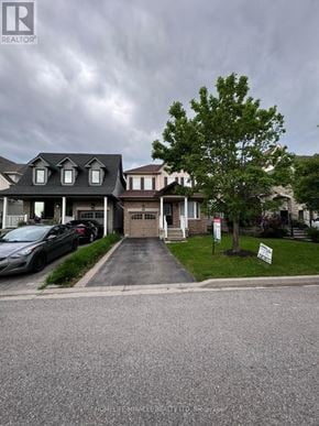 Whitby (Brooklin) apartment for rent - A real estate sign is in front of a house.