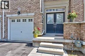 Oakville (Wm Westmount) townhouse for rent - A house with a blue door and a white garage door.
