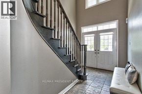 Oakville (Wm Westmount) townhouse for rent - A staircase with a metal railing and a bench at the bottom.