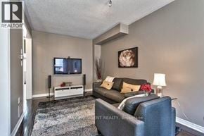 Oakville (Wm Westmount) townhouse for rent - A living room with a grey couch and a television.