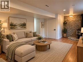 Kitchener apartment for rent - A living room with a couch, a coffee table, and a painting on the wall.