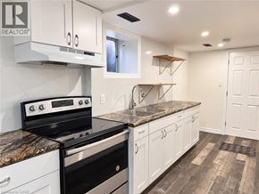 Kitchener apartment for rent - A kitchen with a black and white stove top oven.
