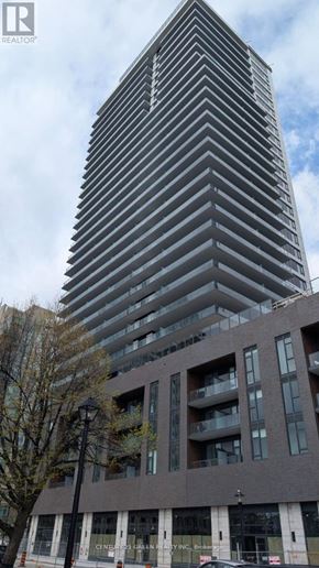 Burlington (Brant) condo for rent - A tall building with a modern design stands next to a smaller, older building.