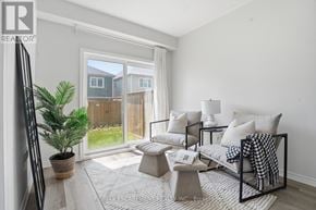 Cambridge townhouse for rent - A living room with a couch, chair, and potted plant.