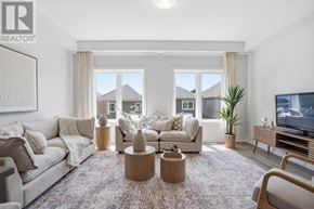 Cambridge townhouse for rent - A living room with a large couch, a coffee table, and a flat-screen TV.
