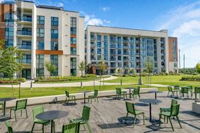 Milton (Walker) condo for rent - A large building with a lawn in front of it.