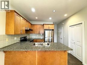 Richmond apartment for rent - A kitchen with wooden cabinets and granite countertops.