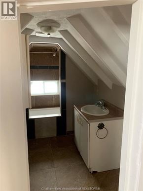 Chatham apartment for rent - A small bathroom with a toilet, sink and mirror.