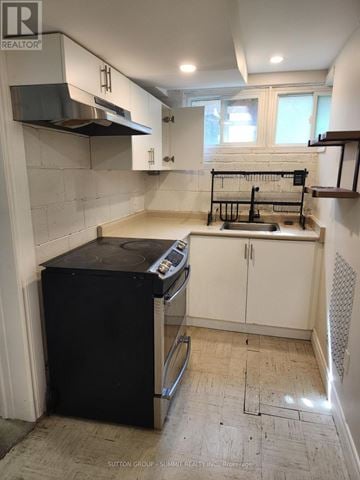 Markham (Markham Village) apartment for rent - A kitchen with a black fridge and white cabinets is for sale.