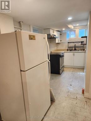 Markham (Markham Village) apartment for rent - A white refrigerator in a kitchen with a counter and cabinets.