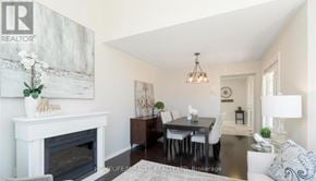 Milton (Ha Harrison) apartment for rent - A well-lit, modern dining room with a fireplace and a painting on the wall.
