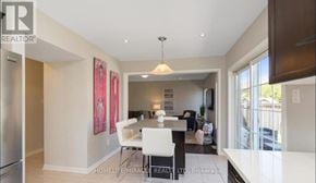 Milton (Ha Harrison) apartment for rent - A dining room with a table set for two and a kitchen area in the background.