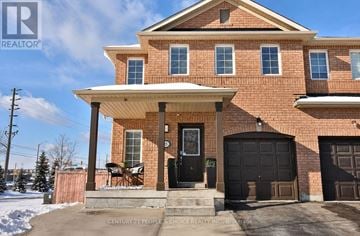Brampton (Fletcher's Meadow) apartment for rent - A house with a black front door and a brick facade.