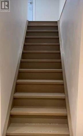 Pickering (West Shore) apartment for rent - A set of stairs leading upwards with a sign on the bottom.