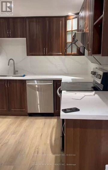 Pickering (West Shore) apartment for rent - A kitchen with wooden cabinets and a white countertop.