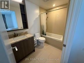 Toronto (Waterfront Communities) condo for rent - A bathroom with a toilet, sink, and bathtub.