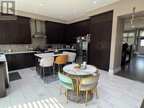 Caledon (Caledon East) apartment for rent - A kitchen with a table and chairs in the middle of the room.
