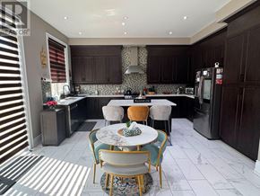 Caledon (Caledon East) apartment for rent - A kitchen with a table and chairs in the middle.