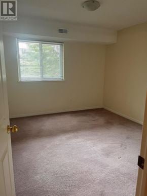 Barrie (Letitia Heights) condo for rent - A room with a carpeted floor and a window with blinds.