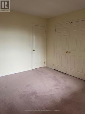 Barrie (Letitia Heights) condo for rent - A room with a carpeted floor and two doors.