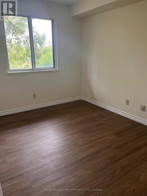 Barrie (Letitia Heights) condo for rent - A room with a window and wooden flooring.