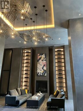 Toronto (Church-Yonge Corridor) condo for rent - A modern living room with a fireplace and a large painting on the wall.