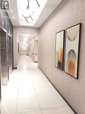 Vaughan condo for rent - A hallway with two paintings on the wall and doors on the left.