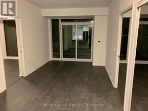 Vaughan condo for rent - A room with a glass door and a white wall.