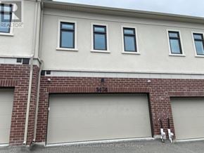 Richmond Hill townhouse for rent - A building with a sign that says "HOMELIFE BROADWAY REALTY INC. Brokerage" in front of it.