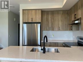 Richmond Hill townhouse for rent - A modern kitchen with a sink and wooden cabinets.