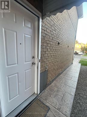 Mississauga (Hurontario) apartment for rent - A white door is open to a brick wall.