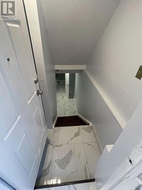 Mississauga (Hurontario) apartment for rent - A hallway with a white door and a marble floor.