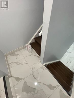 Mississauga (Hurontario) apartment for rent - A staircase with a marble patterned floor.