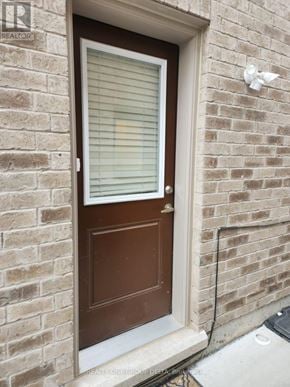 Brampton (Bram West) apartment for rent - A brown door with a white frame is on a brick wall.