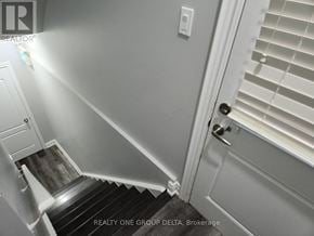 Brampton (Bram West) apartment for rent - A stairway with a light on the left side and a door with blinds on the right side.