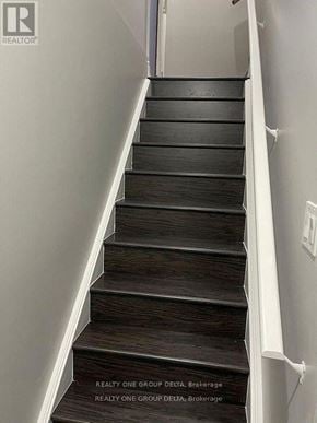 Brampton (Bram West) apartment for rent - A staircase with a sign that says "REALTY ONE GROUP DELTA, Brokerage".