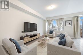 Thorold (Rolling Meadows) apartment for rent - A living room with a grey couch and a flat screen TV.