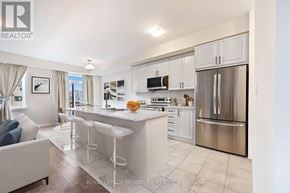 Thorold (Rolling Meadows) apartment for rent - A well-lit kitchen with white cabinets and stainless steel appliances.
