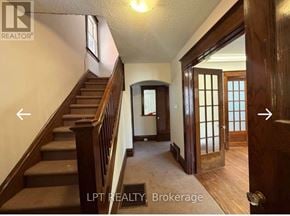 Ottawa apartment for rent - A hallway with a staircase and a door on the right.